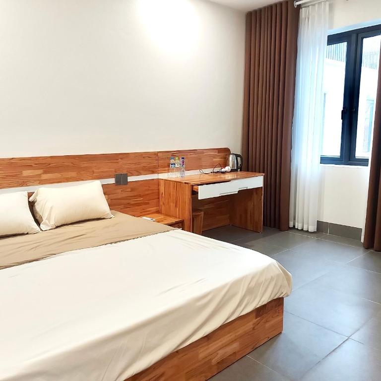 Hotel bedroom with a wooden bed and desk