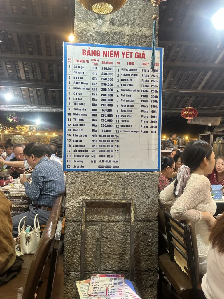 Restaurant food price board showing dishes by the plate and hot pots by the pot.