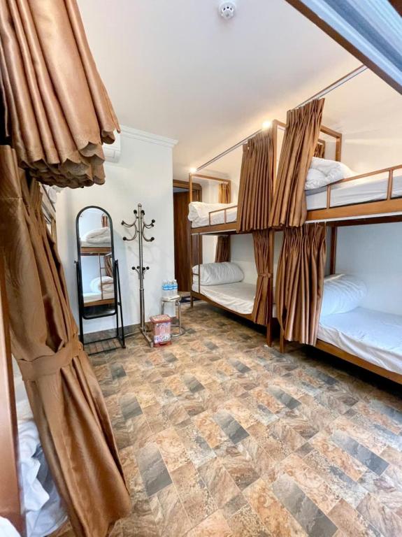 Shared dormitory with bunk beds and privacy curtains