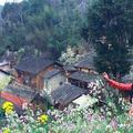 Traditional houses and spring flowers at Lao Xa village, supplied by the user.